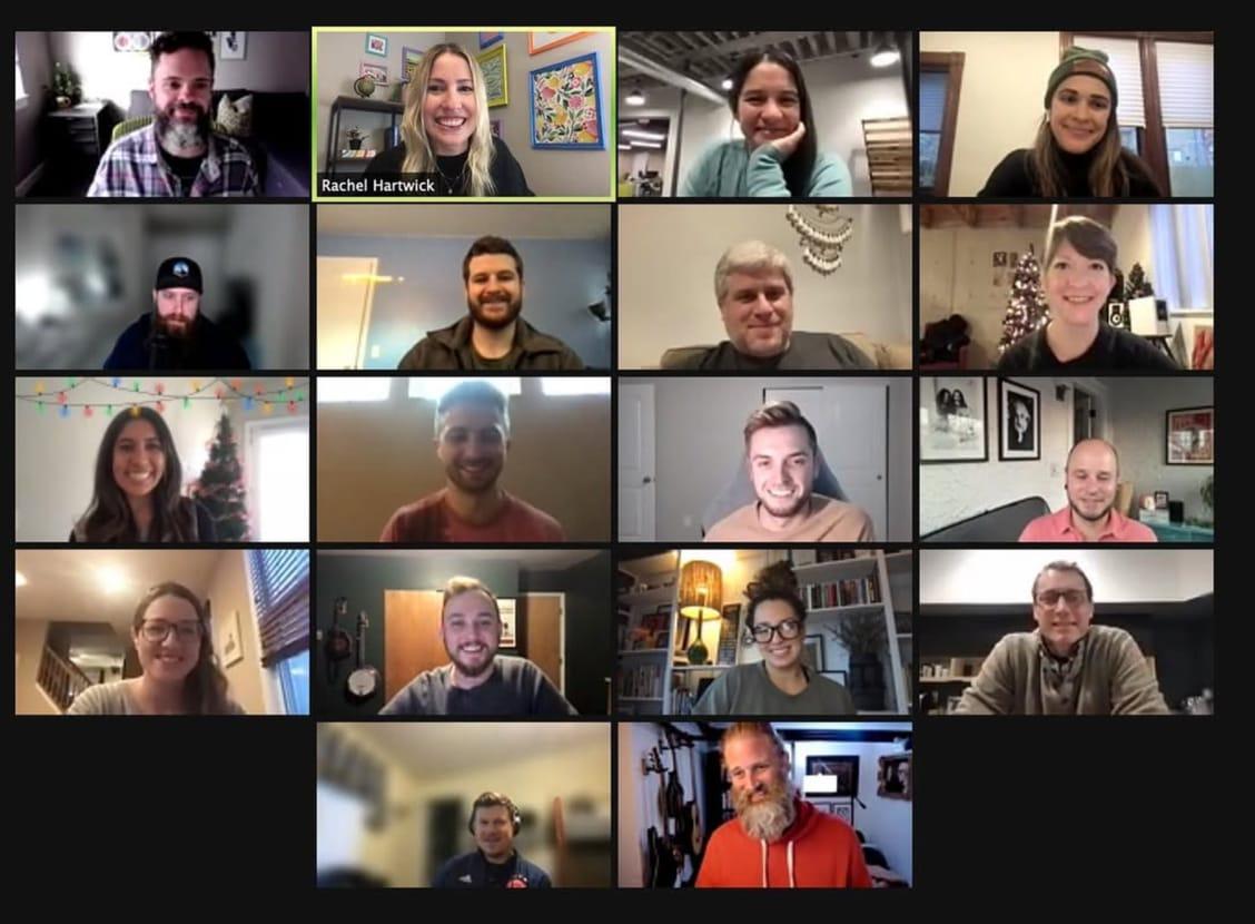 The Ample team on a video call, eighteen faces in a grid